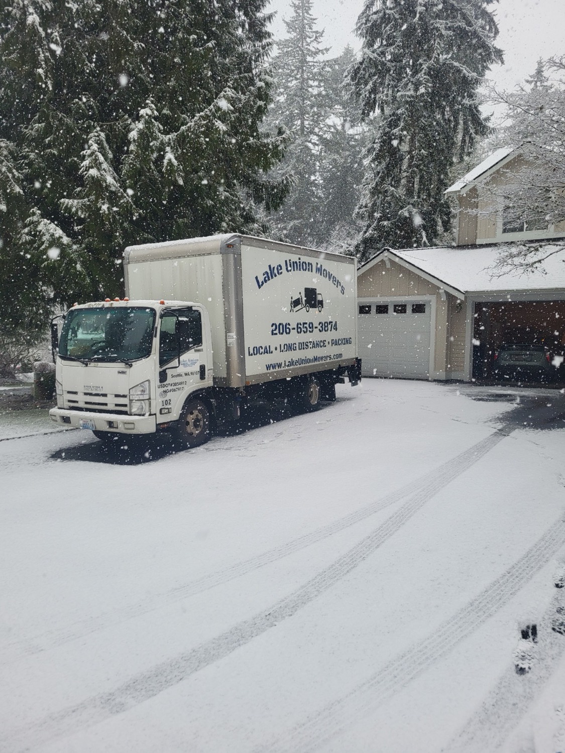 Lake Union Movers box truck in a snowy Seattle driveway